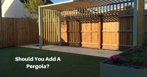 a basic rectangular pergola along a wood fence. Text reads, Shoud you add a pergola