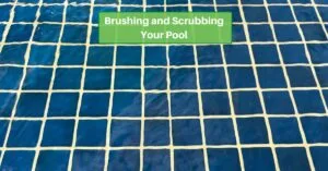 Blue pool tile under clear water. text reads, brushing and scrubbing your pool